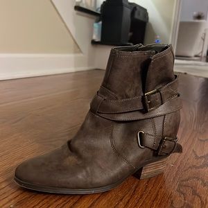 Short 1.5 inch booties. Dark brown color. Inside facing zipper. Buckle detail
